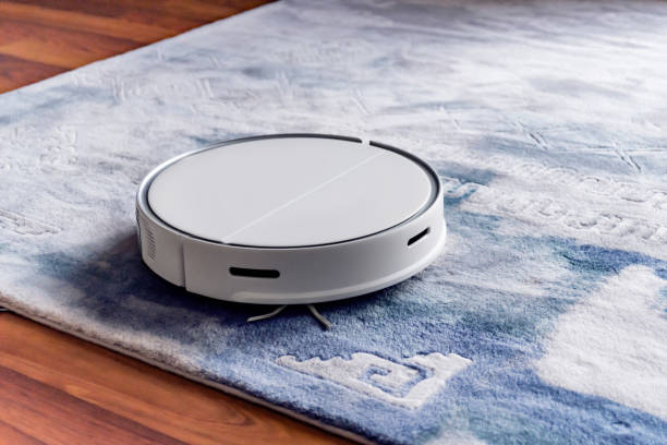 A robotic vacuum is cleaning a carpet
